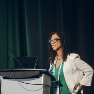 Yumi Wilson speaking at a conference about AI and communication